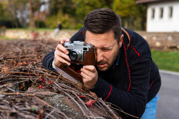 Photographer with vintage analogue film camera outdoors