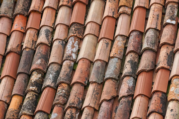 old and new clay roof tiles on the roof