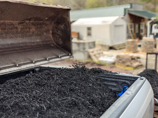 front loader filling pickup and trailer with black mulch © digidreamgrafix