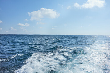 Naklejka na ściany i meble Sailing the ocean, seascape on a sunny summer day.