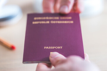 Passport vacation concept: Close up of fingers holding a passport, arrival or departure, “passport”