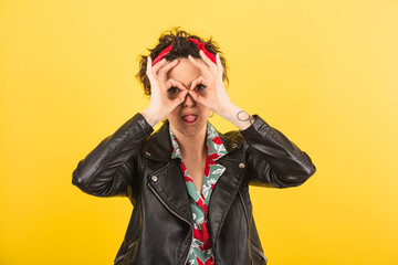 a woman jokes and makes the shape of eyeglasses with her hands