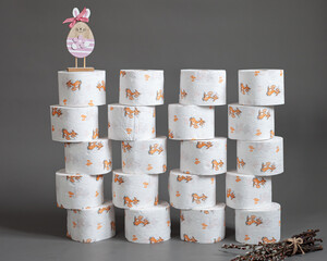 toilet paper and easter rabbit on a grey background