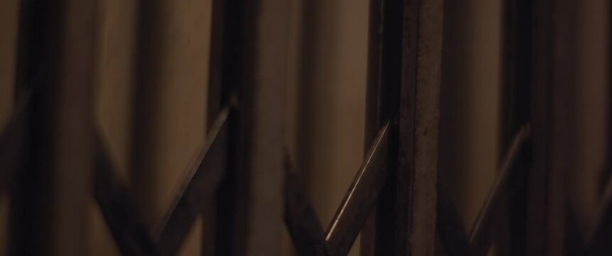 Going down vintage old elevator while seeing floors passing by. Interior view. Slow motion.