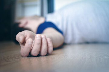 The dead body of a man lies on the floor