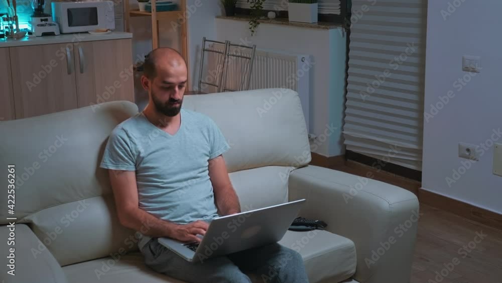 Poster caucasian male sitting in front of television while working at communication project before deadline