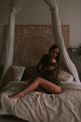 Fototapeta premium Young woman in the bedroom