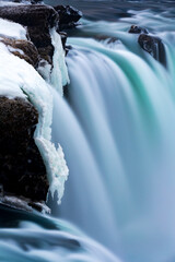 close up of frozen ice and flowing water in Iceland in winter