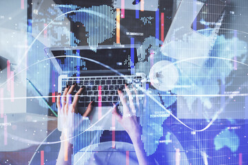 Double exposure of woman hands working on computer and financial theme hologram drawing. Top View. Business concept.