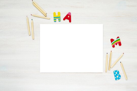 Blank horizontal paper sheets, coloring pages, kids worksheet mockup, pencils and colorful letters.