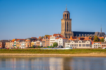 Dutch landschape near the Hanze city of Deventer. The famous Wilhelmina Bridge and the St. Nicholas Church or the Berg Church can be seen. It is a warm and clear summer September day. 