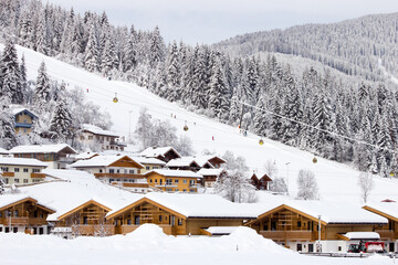 Ski slope and resort houses in the European Alps. Flachau, Austria - 422541293