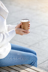 Woman with takeaway cup of tasty latte outdoors