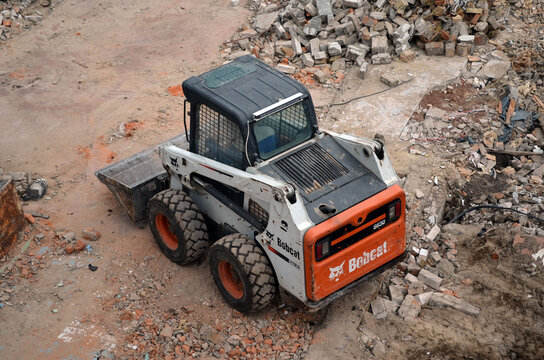 A Bobcat Skid Steer Loader Transports Work On Old House Demolition. 23 March 2021. Kiev Region, Ukraine