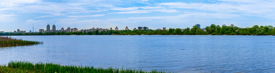 Fototapeta premium Panoramic landscape view of Dnipro river and its Right bank of Obolon district at early spring, Kyiv 
