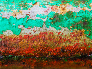 Paint rusting off an old pipe outside an abandoned stable
