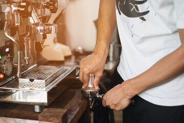 Barista make coffee latte art with espresso machine in cafe vintage color tone. Barista Cafe Making Coffee Preparation Service Concept
