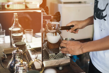Barista make coffee latte art with espresso machine in cafe vintage color tone. Barista Cafe Making Coffee Preparation Service Concept