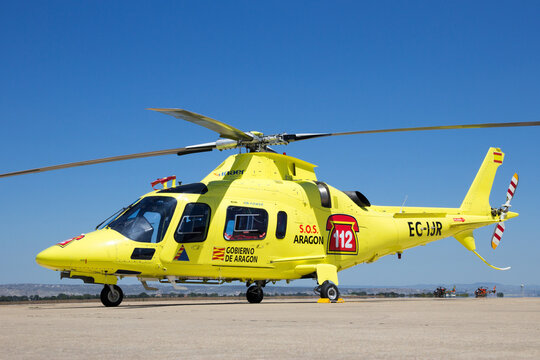 Yellow Inaer Agusta A-109E Power SOS rescue helicopter on the tarmac of Zaragoza airbase, Spain