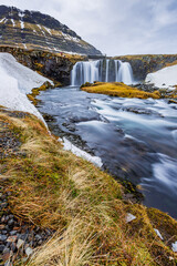 Kirkjufellsfoss, Kirkjufell waterfall roars with water from recent rain in Winter
