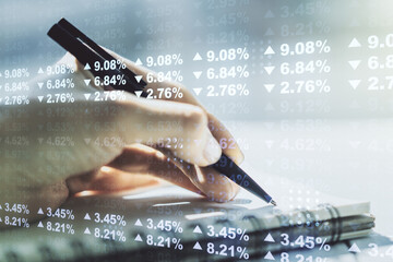 Abstract creative stats data concept with woman hand writing in notebook on background....