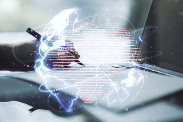 Double exposure of abstract digital world map with connections and hand writing in notepad on background with laptop, big data and blockchain concept