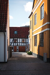 Cobblestoned alley with old crooked half-timbered houses in Lund Sweden