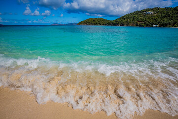 Motion waves break on the shore on Hawksnest beach in St. John