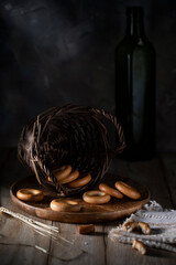 Cookies in a wooden plate on a rustic table