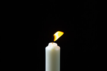 Burning candle on a black background. Fire candles on a dark background. Little light