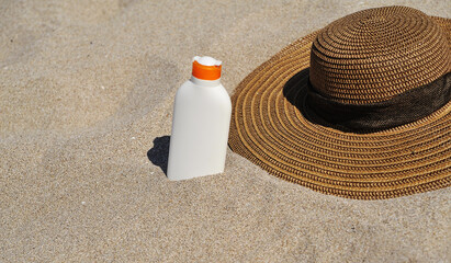 sunscreen and hat on the beach