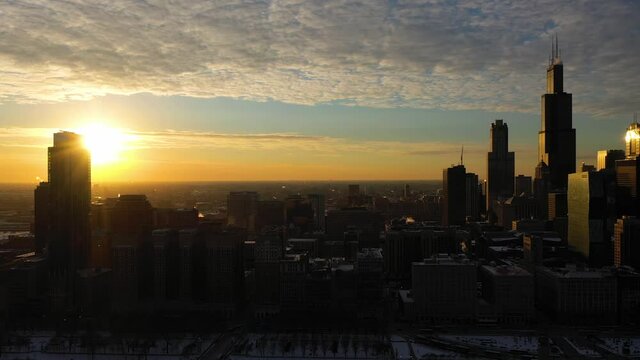 Urban Skyline of Chicago Loop at Sunset in Frosty Winter Evening. Golden Hour. Aerial View. United States of America. Drone Flies Sideways