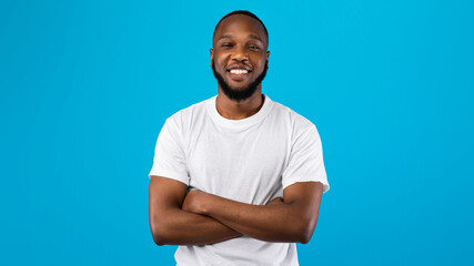 Fototapeta premium Portrait Of Happy African American Guy Over Blue Background, Panorama