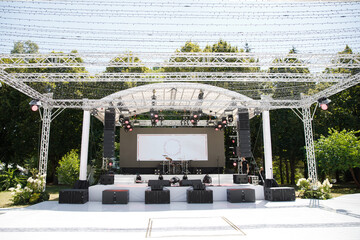 Beautifully decorated stage for the performance of artists. Summer day and preparation for the party