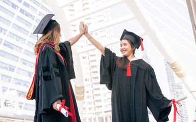 Two asian women happy with graduation