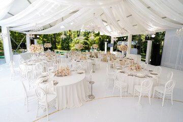 Festive wedding table setting with flowers, napkins, cutlery, glasses, bright summer table decor....