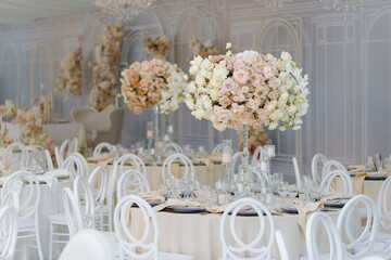 Festive wedding table setting with flowers, napkins, cutlery, glasses, bright summer table decor....