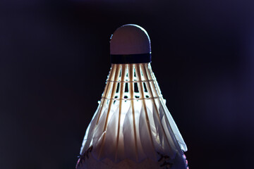 Shuttlecock made by feathers in dim light . Goose Feather Badminton Shuttlecocks with Great Stability