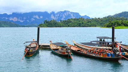 Fototapeta na wymiar Longtail boats on the Cheow Lan Lake, Khao Sok National Park, Thailand