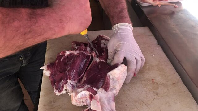 butcher cutting beef, butcher cutting lamb meat