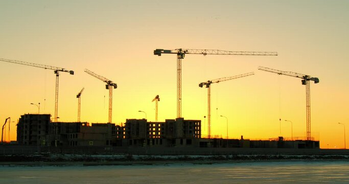 Construction of multi-storey buildings using tall cranes.