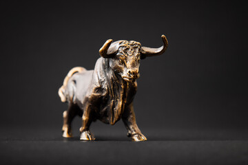 Bull figurine isolated on black background