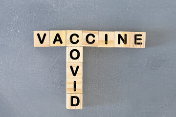 Covid-19 vaccine. Crossword with vaccine and covid. Letters on wooden blocks