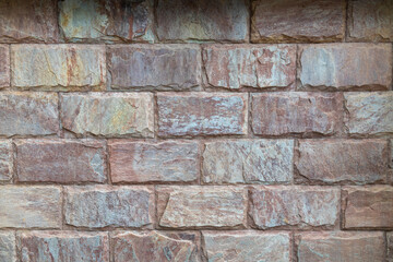 Rectangular cut granite stone wall in colorful tones