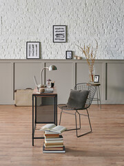 Working room at home style with wooden table laptop and metal black chair, poster brick wall.