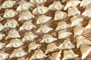 Raw dumplings background. Cooking dumplings in the kitchen.