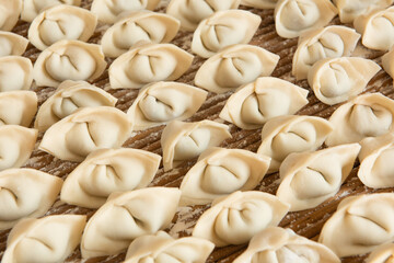 Raw dumplings background. Cooking dumplings in the kitchen.