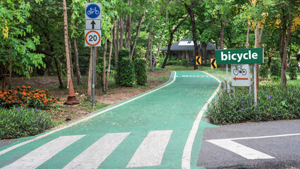 A lane used for cycling in a park surrounded by trees on either side.