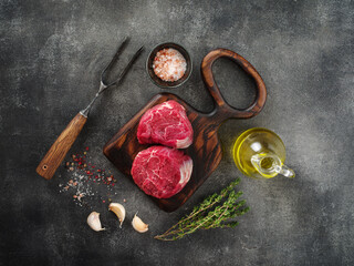 Fototapeta na wymiar Raw filet mignon steaks with herbs and spices, Raw fresh marbled meat Steak, top view, flat lay.