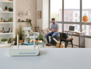 Close up modem box on the table, decorative home concept technological tool background style. Man is using phone.